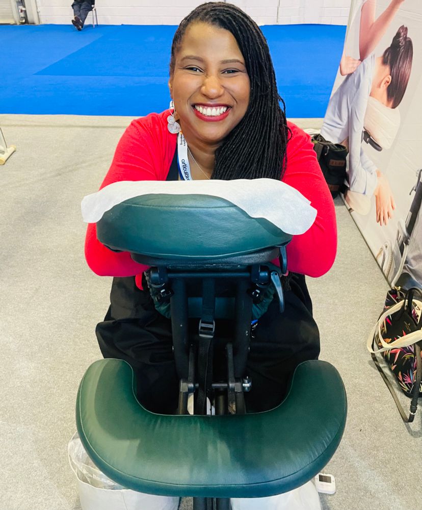 Dana the post’s author in a massage chair preparing for her own massage at the conference 