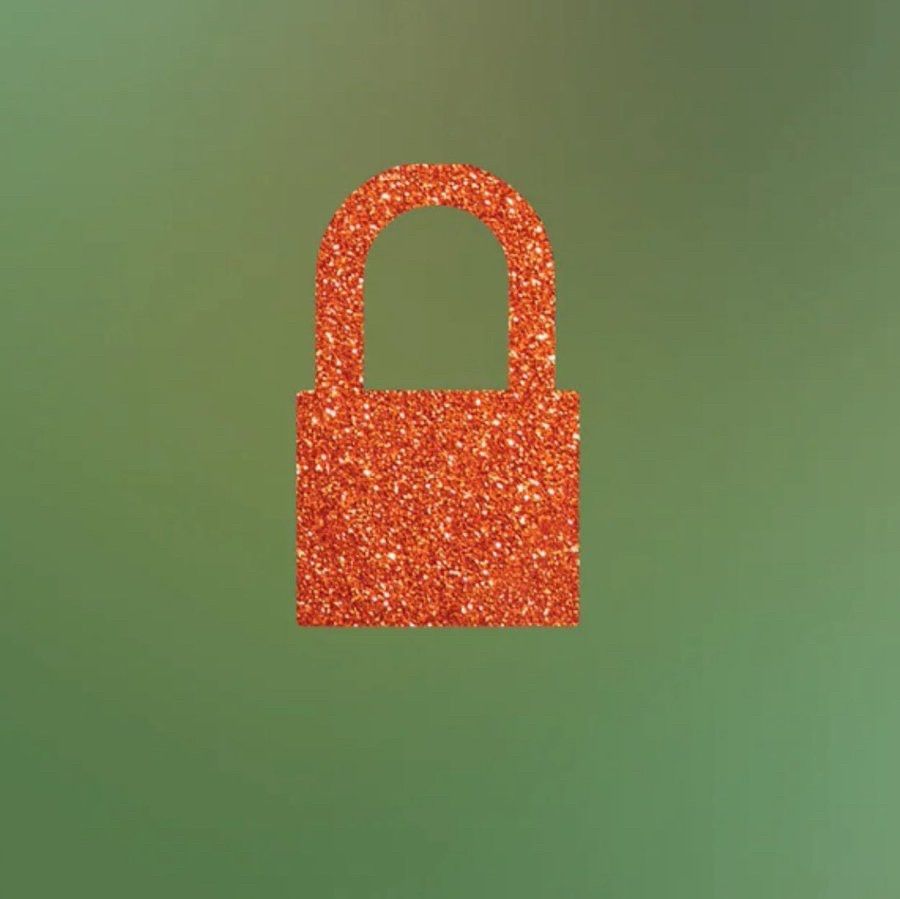 Blurred green/ aqua background with a glittery ornage lock on top