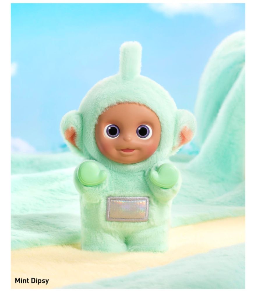 Small Teletubby doll with mint green plush fur on a pastel green, yellow, and blue plush background. It says "mint Dipsy" in the bottom left corner.