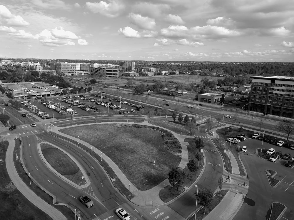 Overhead view of a city with rounded drives and sidewalks. 