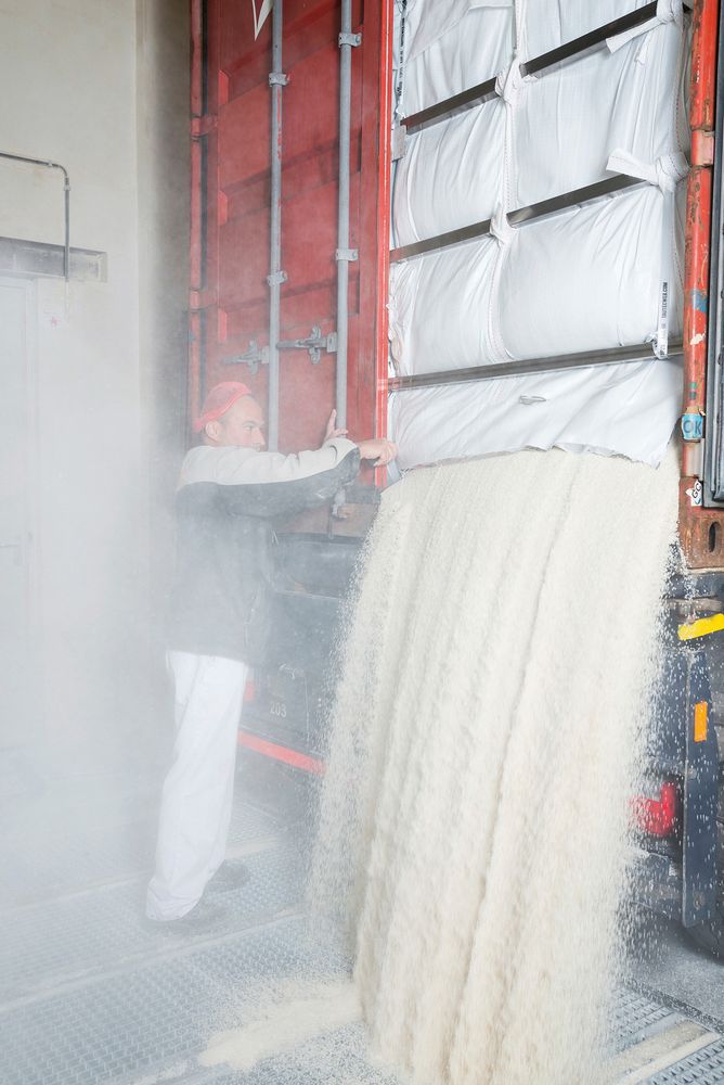 Ayhan Misirli, an employee of the Dutch company Lassie, unloads a truck with rice