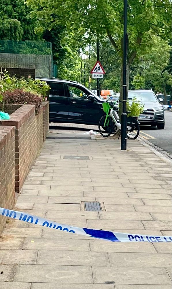 A police cordon in front of a car which has struck a child on the pavement
