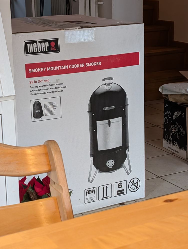 A picture of a 22 inch Weber Smokey Mountain Cooker Smoker. Brand new in the box 