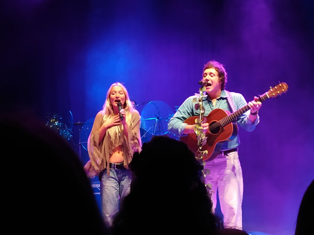 Matt is singing holding his guitar with Jo Hill, one of their support act for this gig. Matt is on the right hand side and Jo is on the left.