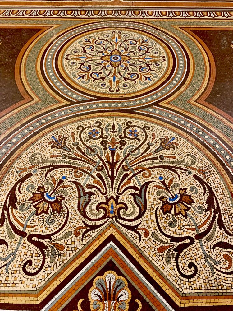 A vintage tile floor with a floral motif at the Chicago Athletic Association.