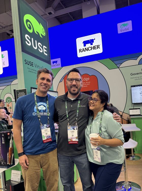 Orlin, Robert, and Divya in front of the SUSE booth at KubeCon NA