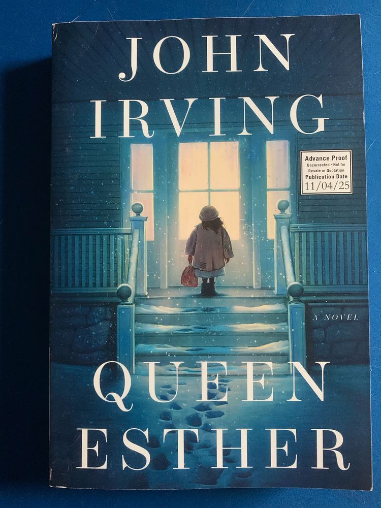 book cover for queen esther by john irving with off-white lettering over an illustration of a small child standing on a porch in front of a lighted doorway on a snowy night