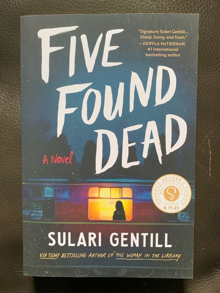 book cover for five found dead by sulari gentill with white lettering over an image of a red train car at night with trees in the background and a figure silhouetted in a lit window