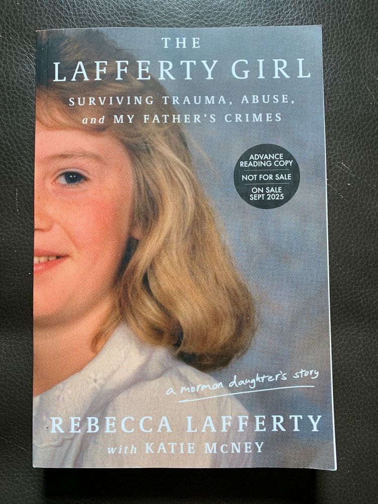 book cover for the lafferty girl by rebecca lafferty with white lettering over half a school picture type portrait of a young light skinned light haired female wearing a white shirt