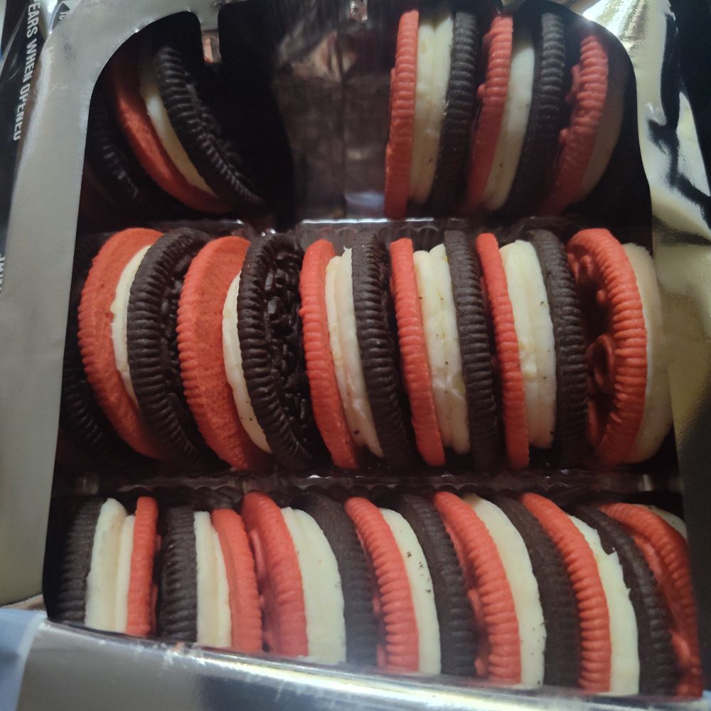Cola Oreos with clearly visible two layers of middle stuff