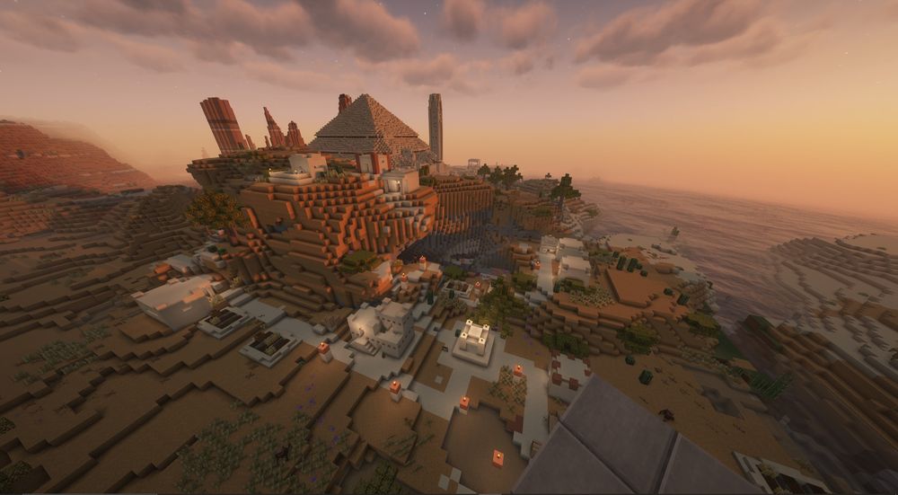 A Minecraft desert village being overlooked by a pyramid 