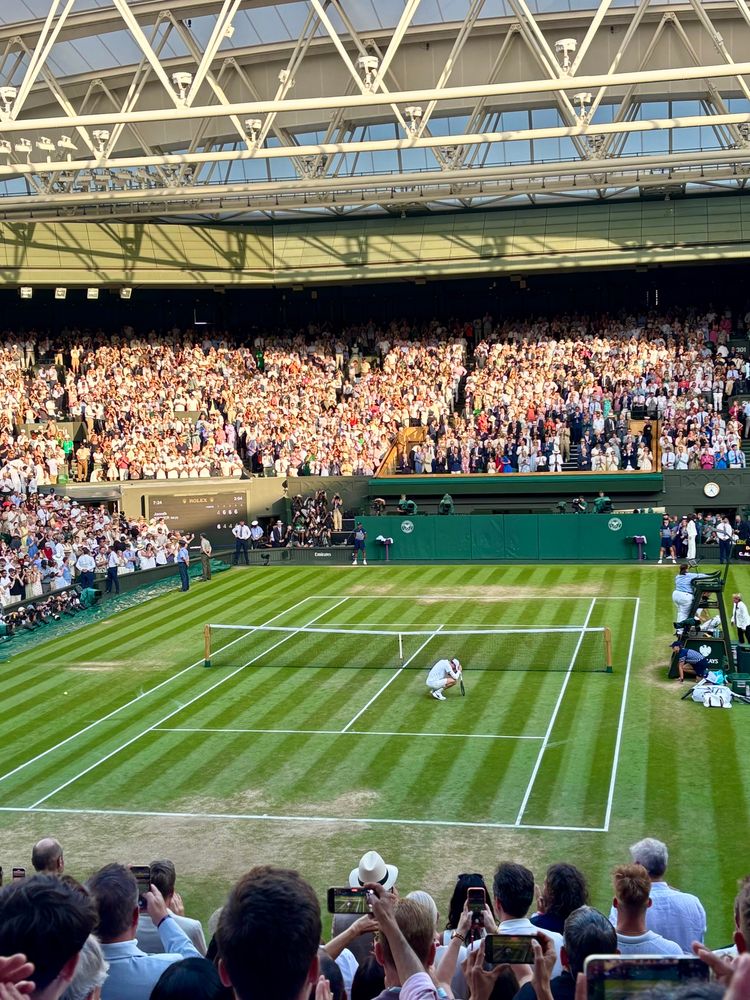 Jannik Sinner on court after winning Wimbledon