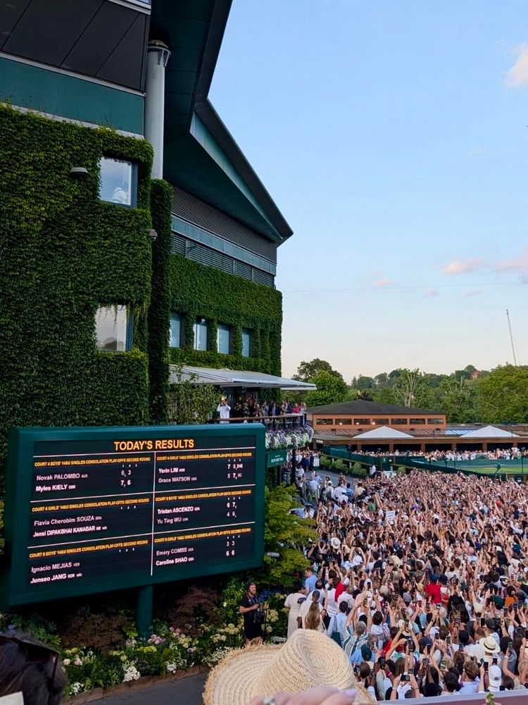 Jannik Sinner with the Wimbledon trophy on the centre court balcony 
