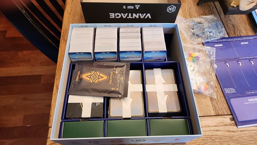 Photo of the open box of the board game "Vantage". Showing over 1000 cards neatly stacked and separated.