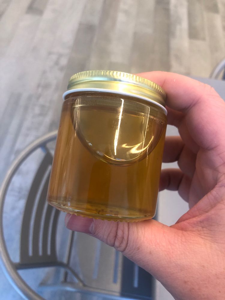 A glass jar full of honey 