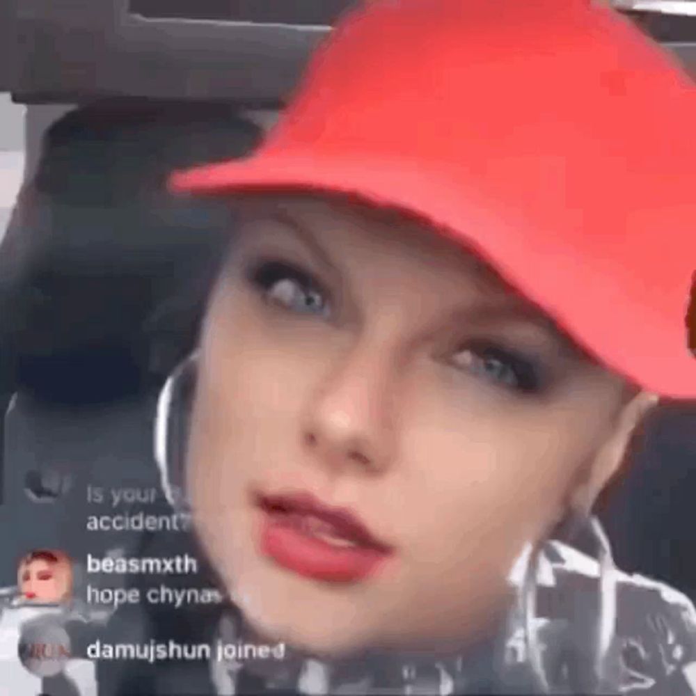 a close up of a woman wearing a red hat and earrings .