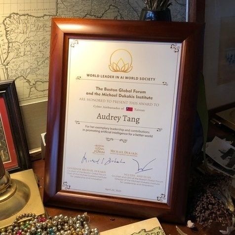 A framed 2025 World Leader in Artificial Intelligence World Society Award presented to Audrey Tang, Taiwan’s cyber ambassador and first digital minister.