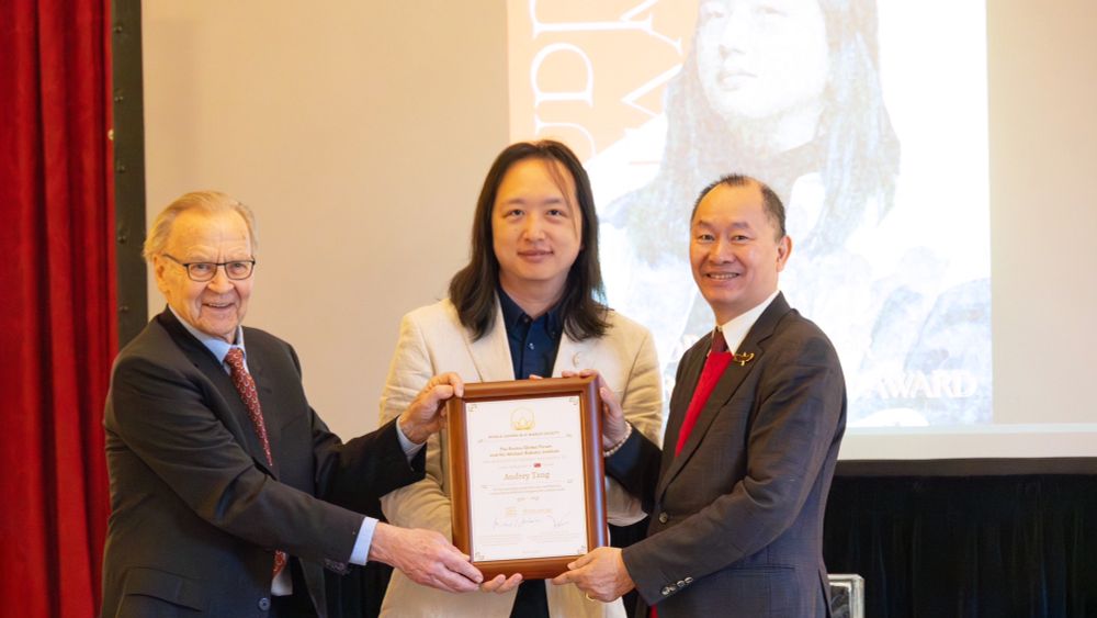 Audrey Tang (centre), Taiwan’s cyber ambassador and first digital minister, displays the Boston Global Forum’s 2025 World Leader in Artificial Intelligence World Society Award presented by Michael Dukakis (left), co-chair of BGF, chair of the Michael Dukakis Institute for Leadership and Innovation and former governor of Massachusetts, and Nguyen Anh Tuan (right), co-chair and CEO of BGF and director of MDILI, at Harvard University Loeb House.