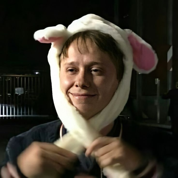 And image of Conor Mason wearing a bunny hat and smiling calmly as he pulls the side arms around his chin.