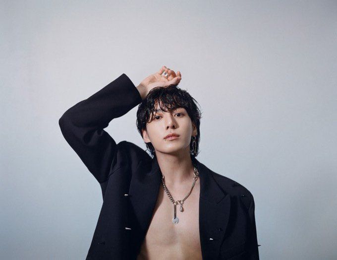 jungkook looking handsome as hell  wearing an open jacket a necklace and no shirt