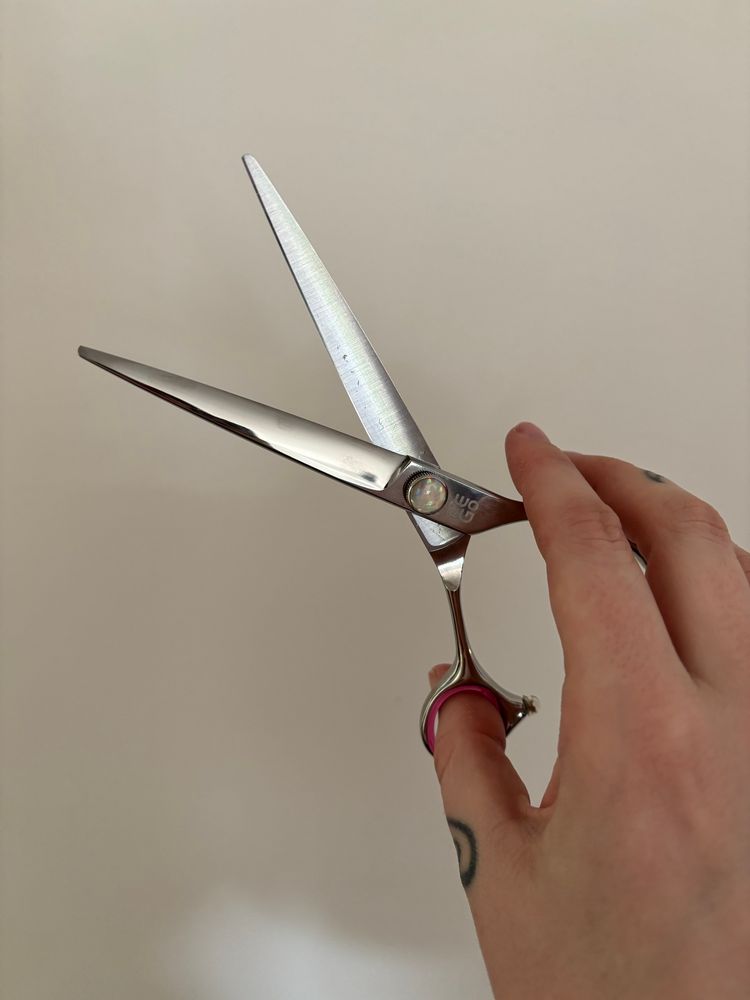 hand holding an open set of 6.5” excellent edges EEGO scissors. it has like a cute lil gem on the pivot, im obsessed 
