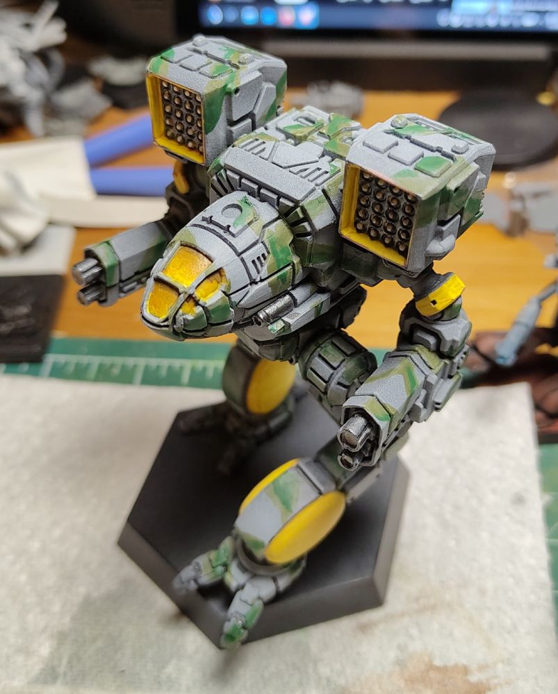 Blue-grey and green camouflage pattern applied and yellow base colour where checkerboard patterns will be placed