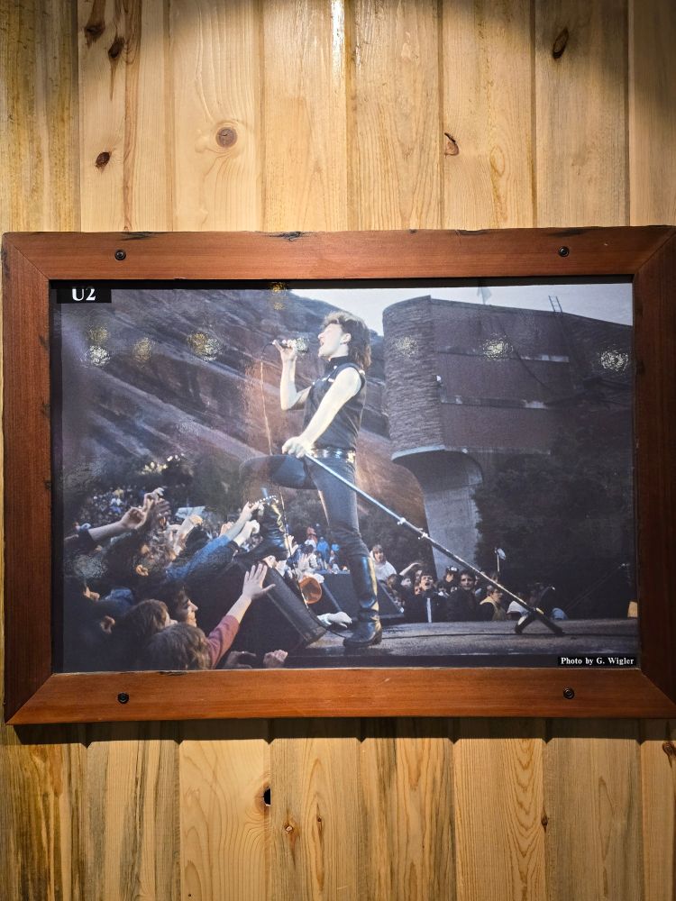 A photo of Bono from U2 singing at Red Rocks