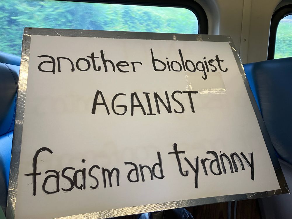 Sign says ANOTHER BIOLOGIST AGAINST FASCISM AND TYRANNY