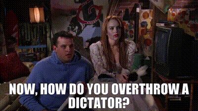 GIF of scene from the film Mean Girls where Janis and her friends plot to dethrone popular girl Regina George. Text: “Now, how do you overthrow a dictator?”