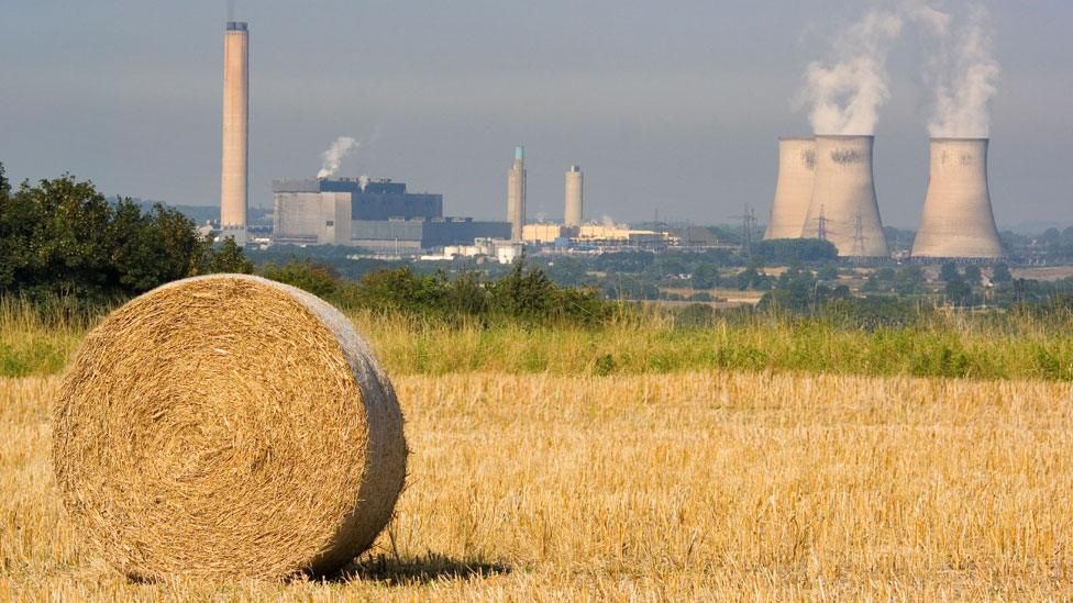 A bucolic scene of a field in late summer with Didcot Power Station in all its glory in the distance.