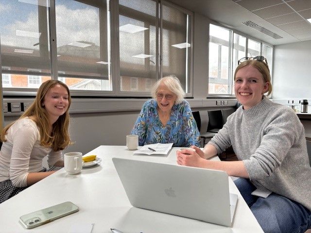 2 students and a patient rep smiling 