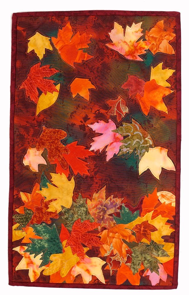 Quilted fall leaves in red, yellow, orange and green. 