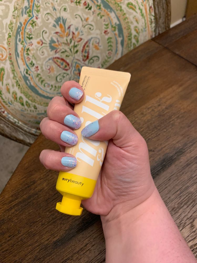 Close up of light blue nails tipped with pink sparkles