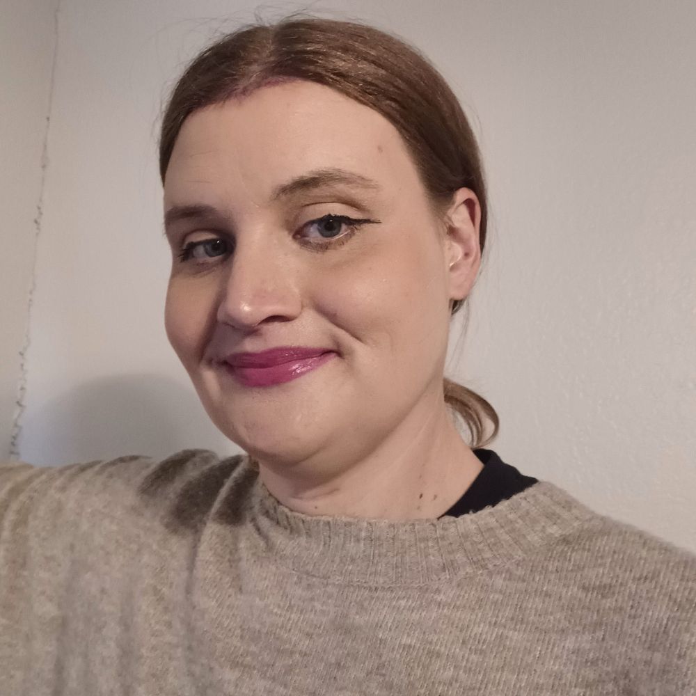 Jenni in makeup wearing her creme sweater 