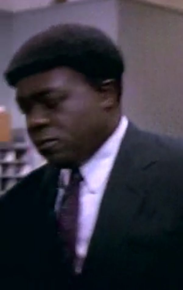 Yaphet Kotto (RIP) as Gee, the chief from Homicide: Life on the Streets. His hair is sculpted into a shape not dissimilar to a baseball helmet complete with brim. Sorry for the blurry screencap, it's almost always seen most clearly when he's in motion