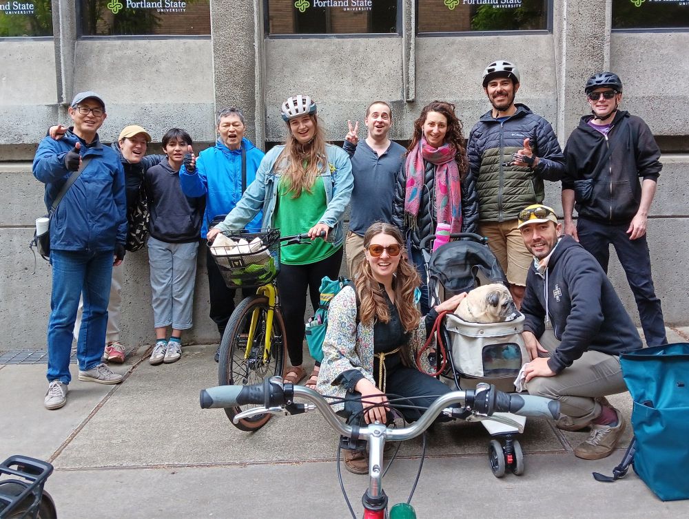 Farmers market cyclists led by adorable pug