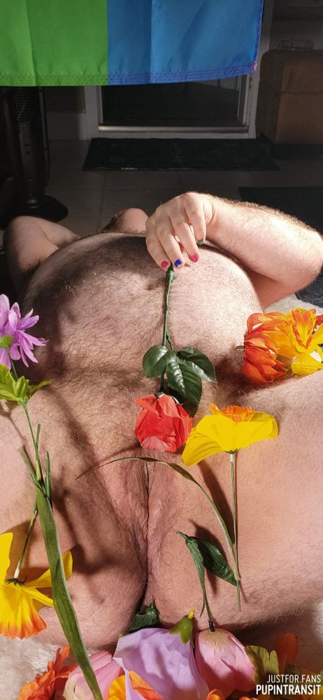 Fat hairy man's vagina admidst flowers