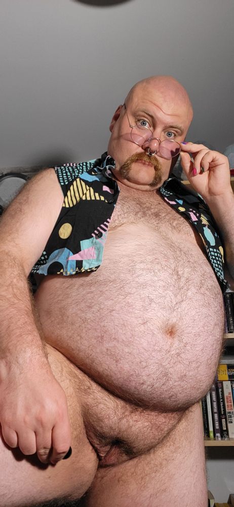 Fat hairy man w/ a vagina tilts glasses at the camera
