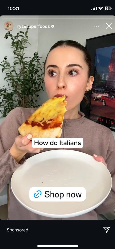 Brunette woman eating a terrible looking pizza in a screenshot of an ad. Caption reads “how do Italians” there’s a “shop now” button 