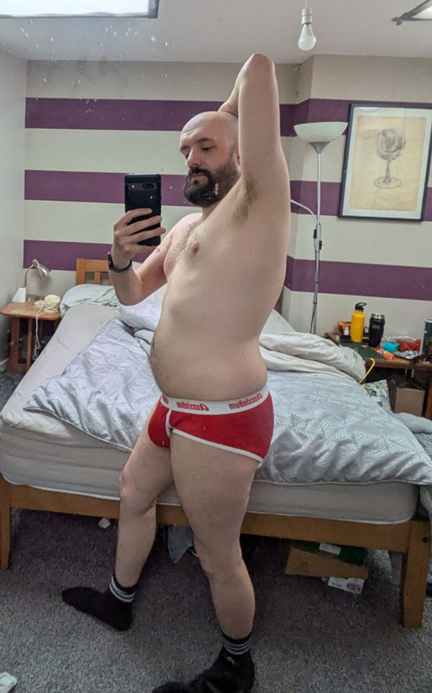 Stood in a pair of red briefs with my arm up showing the armpit and taking a selfie in the mirror 