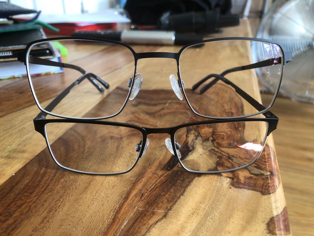 Two Ronnies styley, two pairs of eyeglasses stacked on top of each other