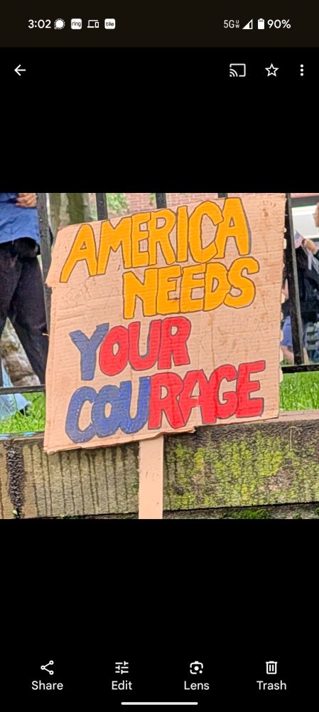 Hand-painted protest sign: America needs your courage
