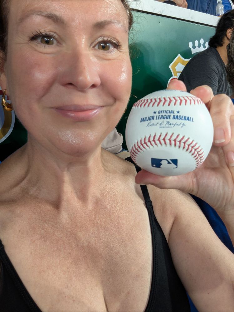 A picture of me holding up the baseball I caught during batting practice!