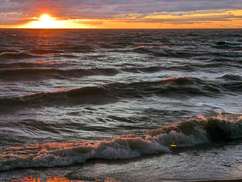 The sun sets on a very wavy Lake Huron, Ontario, Canada.