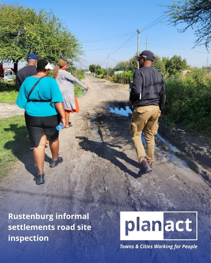 Planact team with community representatives and municipal officials inspecting a swampy road in Rustenburg. 