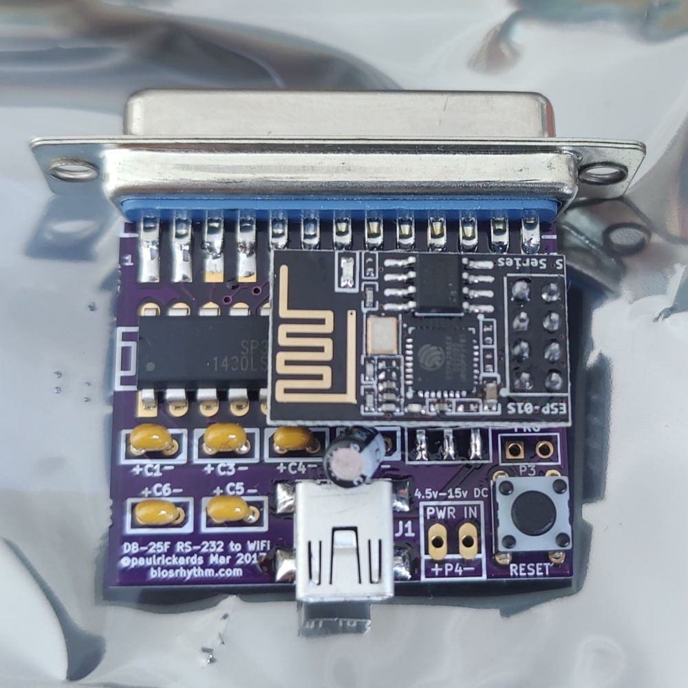 Photo of a WiFi232. At the top is an RS-232C connector. A serial chip is partially visible behind an ESP8266 module.