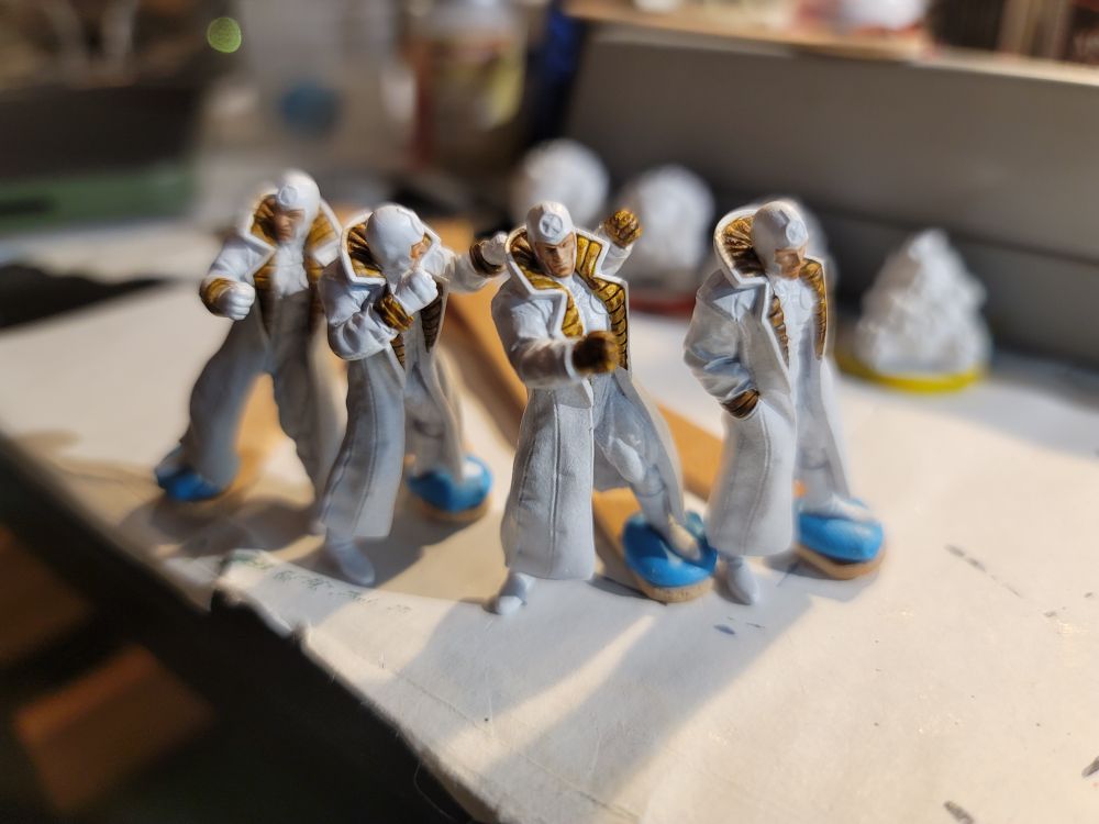 Multiple Man 3d prints for Marvel Crisis Protocol, Multiple Man (Jamie Maddox) is a mutant in a trench coat and body suit who can make copies of himself, there are 4 of him  with leather painted on the collar of his trench coat.