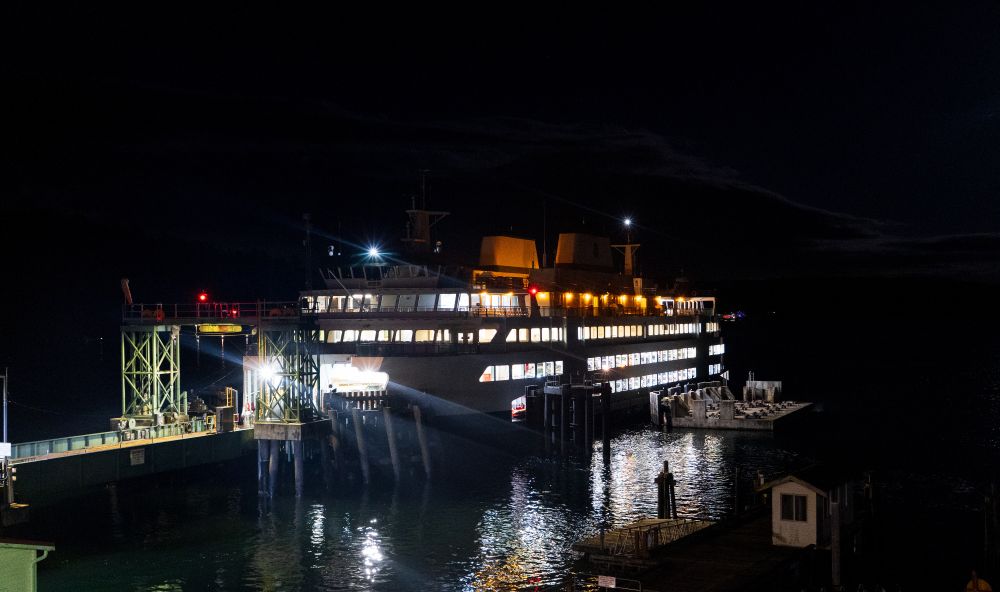 Washington State Ferry Salish docked at Orcas Island at night as seen from shore