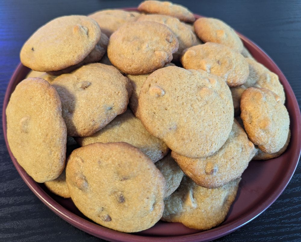 A plate piled high with chocolate chip cookies.