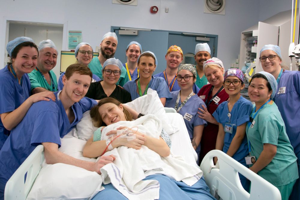 Husband Angus, Grace and baby Amy Isabel, with their (delivery) medical team.